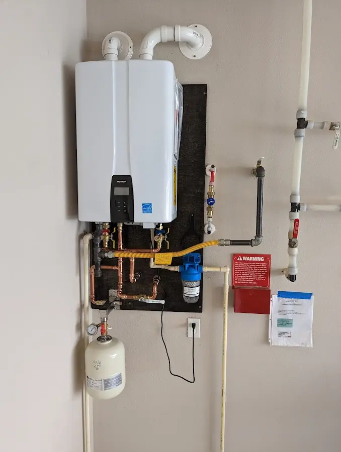 Professional plumber installing copper piping in a Pima home